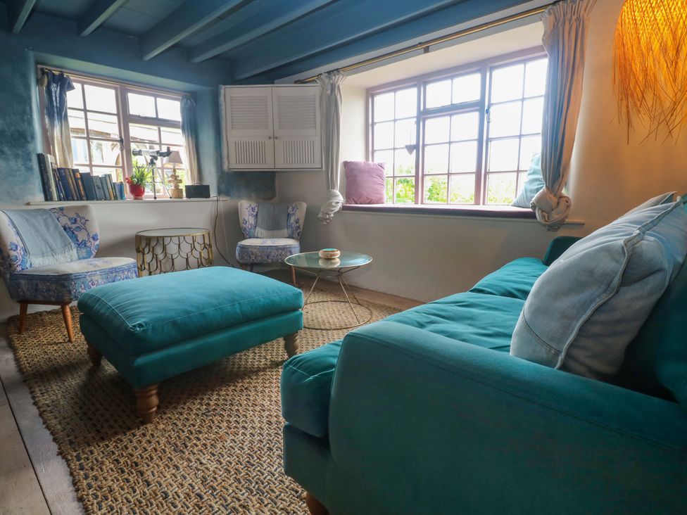 A living room with a sofa and chairs at Mermaid Cottage in Coverack near St Keverne