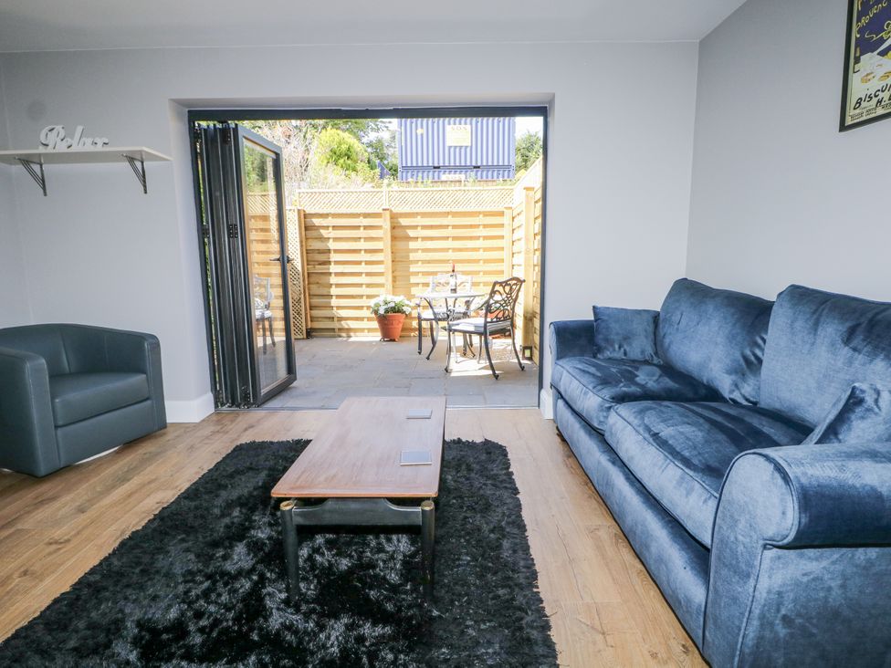 A living room with a sofa and coffee table at Sunnyfield Cottage