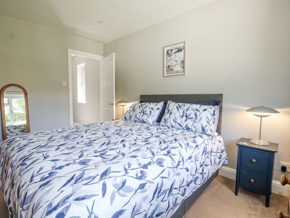 A bedroom with a bed and bedside table at Sunnyfield Cottage 