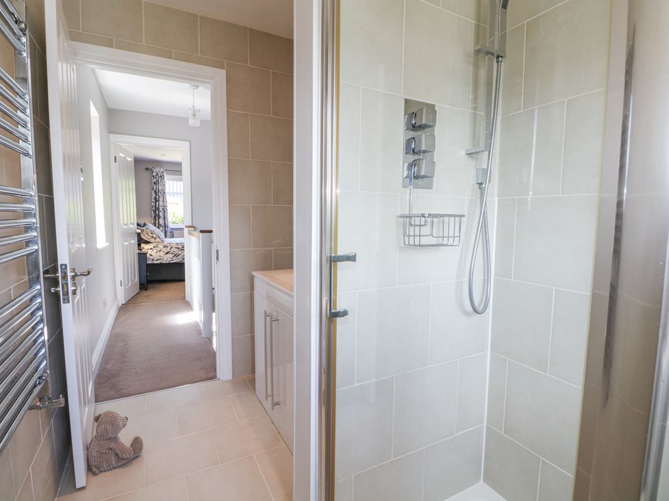 A bathroom featuring a shower and towel radiator at Sunnyfield Cottage
