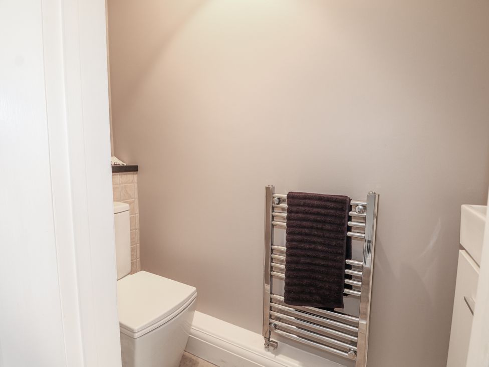 A bathroom with a toilet and towel rail at Sunnyfield Cottage