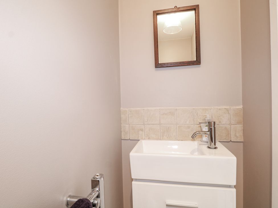 A bathroom featuring a sink and mirror at Sunnyfield Cottage