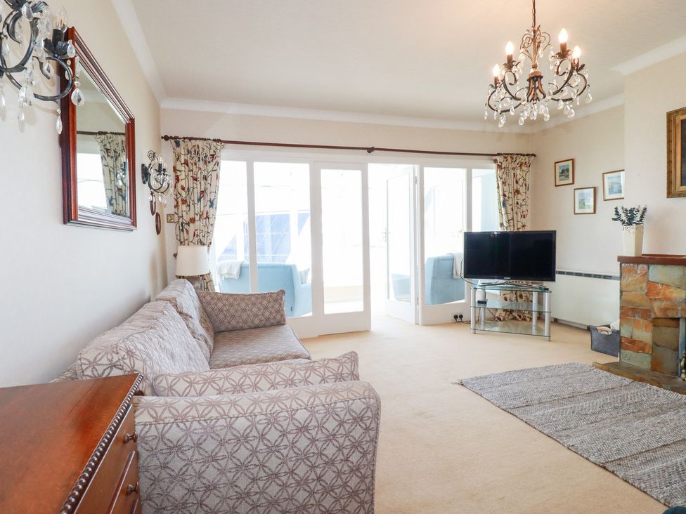 A living room with a sofa and television at 22 Pentire Avenue Newquay