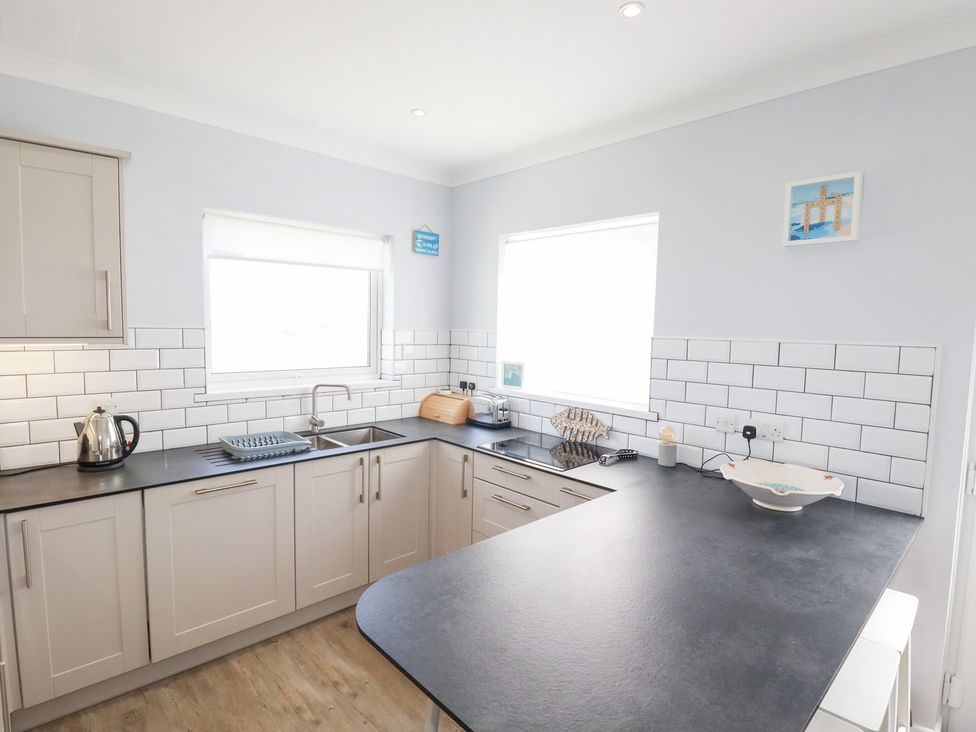 A kitchen with cabinets, sink, and countertop at 22 Pentire Avenue in Newquay