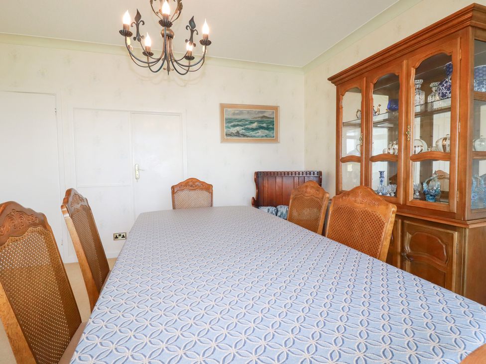 A dining room with a table and chairs at 22 Pentire Avenue in Newquay