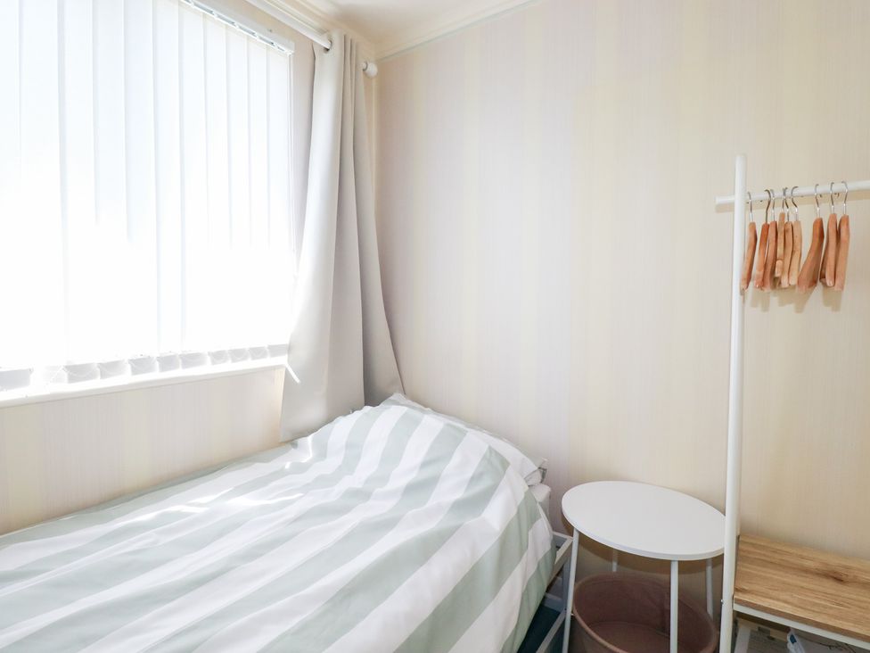 A bedroom with a bed and bedside table at 22 Pentire Avenue Newquay