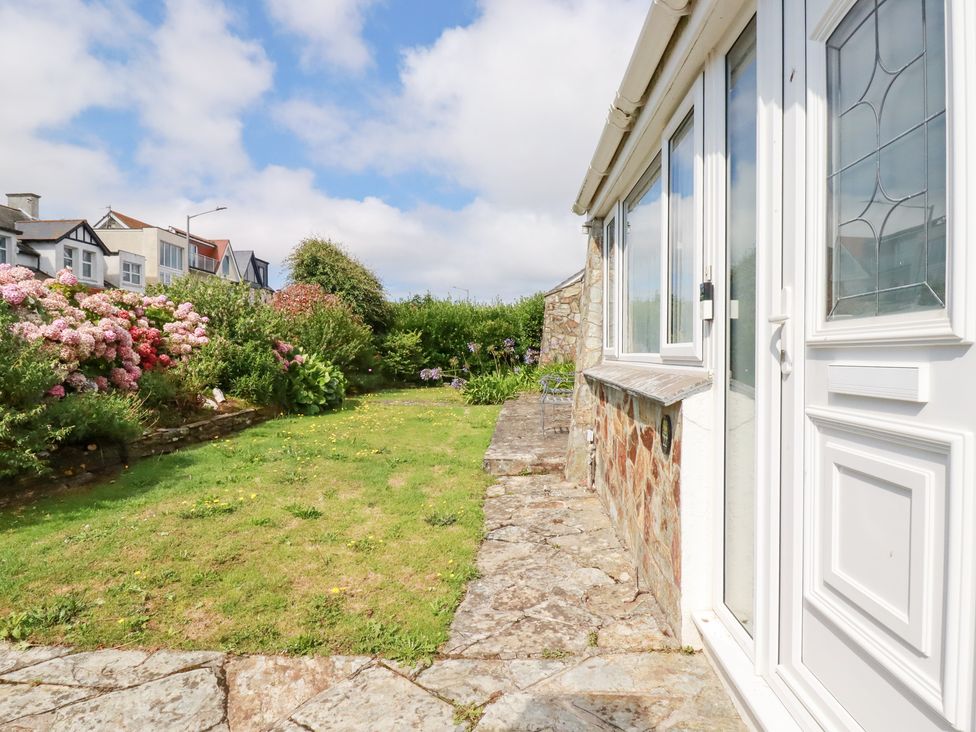 A garden with flowers and grass at 22 Pentire Avenue, Newquay
