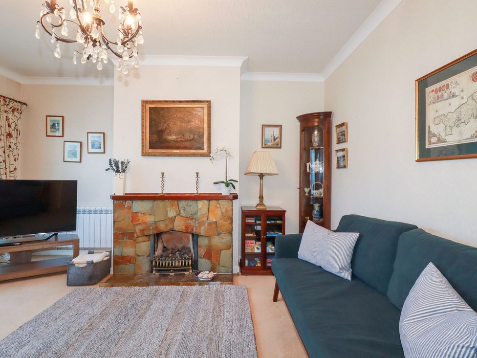 A living room with a sofa and television at Pipers in Newquay