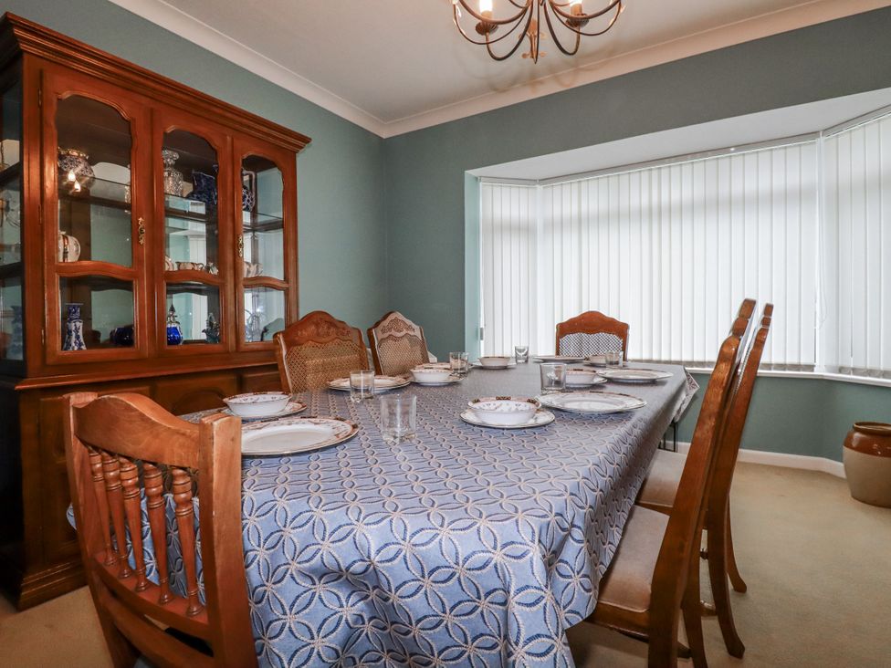 A dining room with a table set for a meal at Pipers Newquay