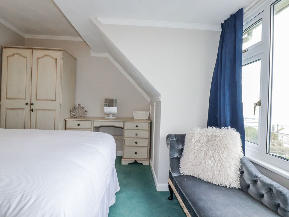 A bedroom with a bed and wardrobe at Pipers in Newquay