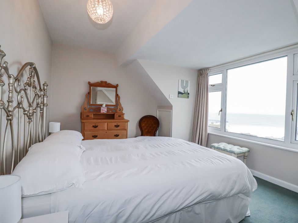 A bedroom with a bed and window at Pipers in Newquay