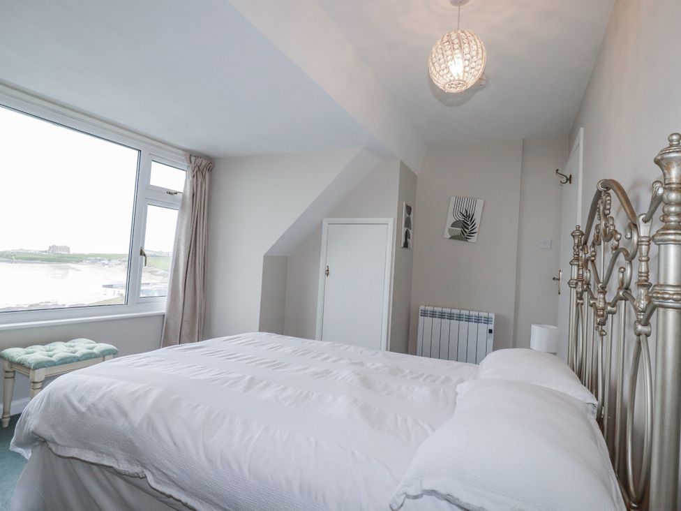 A bedroom with a bed and view at Pipers in Newquay
