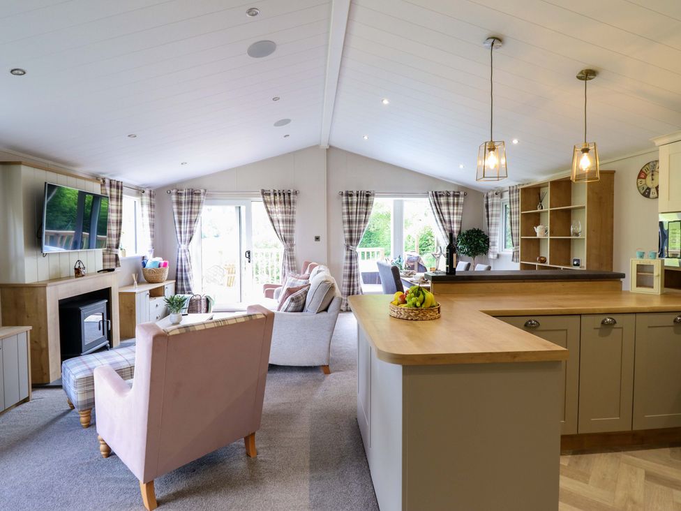 A living room with a television and sofa at The Owlet Dolwen near Llanidloes