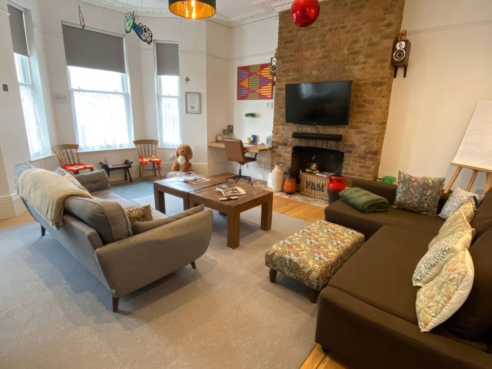 A living room with a sofa and television at Church Retreat in St. Leonards-on-Sea