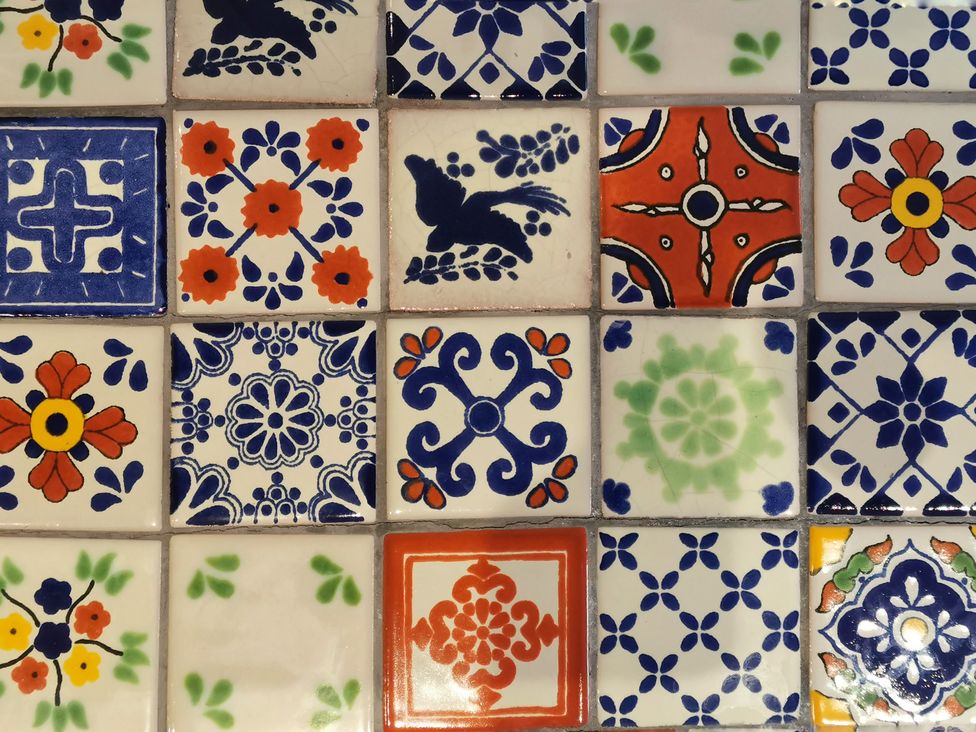 A collection of decorative ceramic tiles with various patterns at Church Retreat in St. Leonards-on-Sea