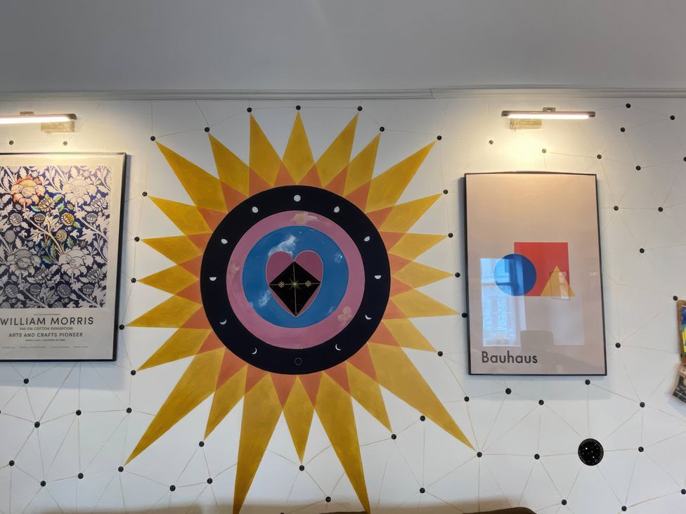 A living room wall with William Morris print and Bauhaus poster at Church Retreat in St. Leonards-on-Sea