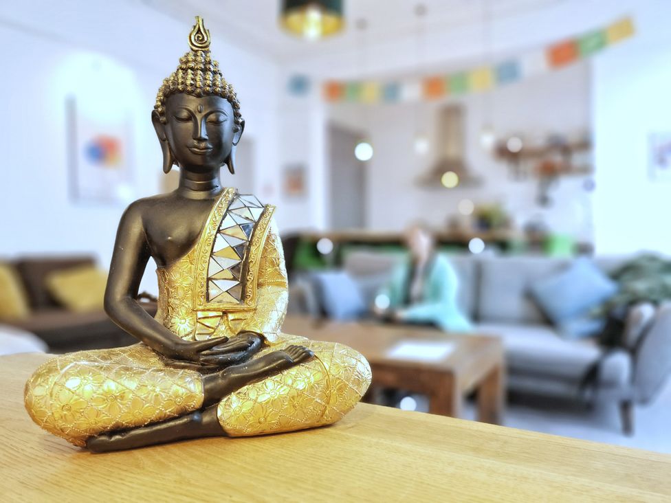 A buddha statue on a table in a living room at Church Retreat in St. Leonards-on-Sea