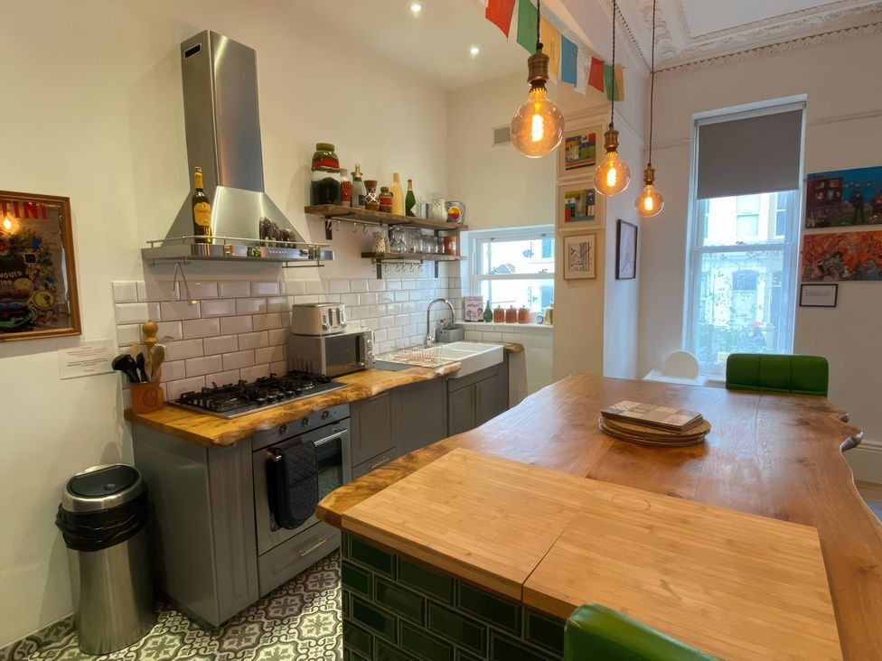 A kitchen with a gas stove and kitchen island at Church Retreat in St. Leonards-on-Sea