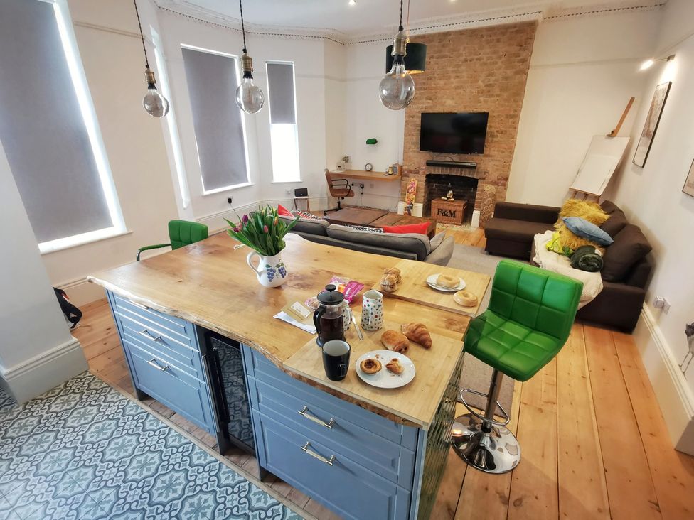 A kitchen with an island and seating at Church Retreat St. Leonards-on-Sea