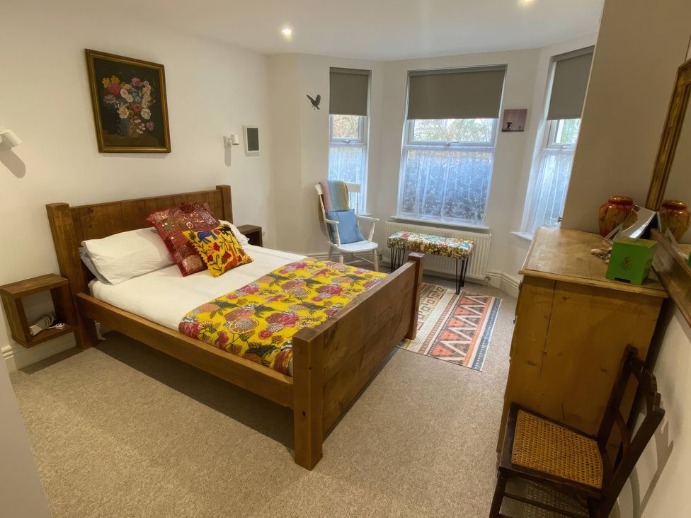 A bedroom with a bed and a chair at Church Retreat in St. Leonards-on-Sea