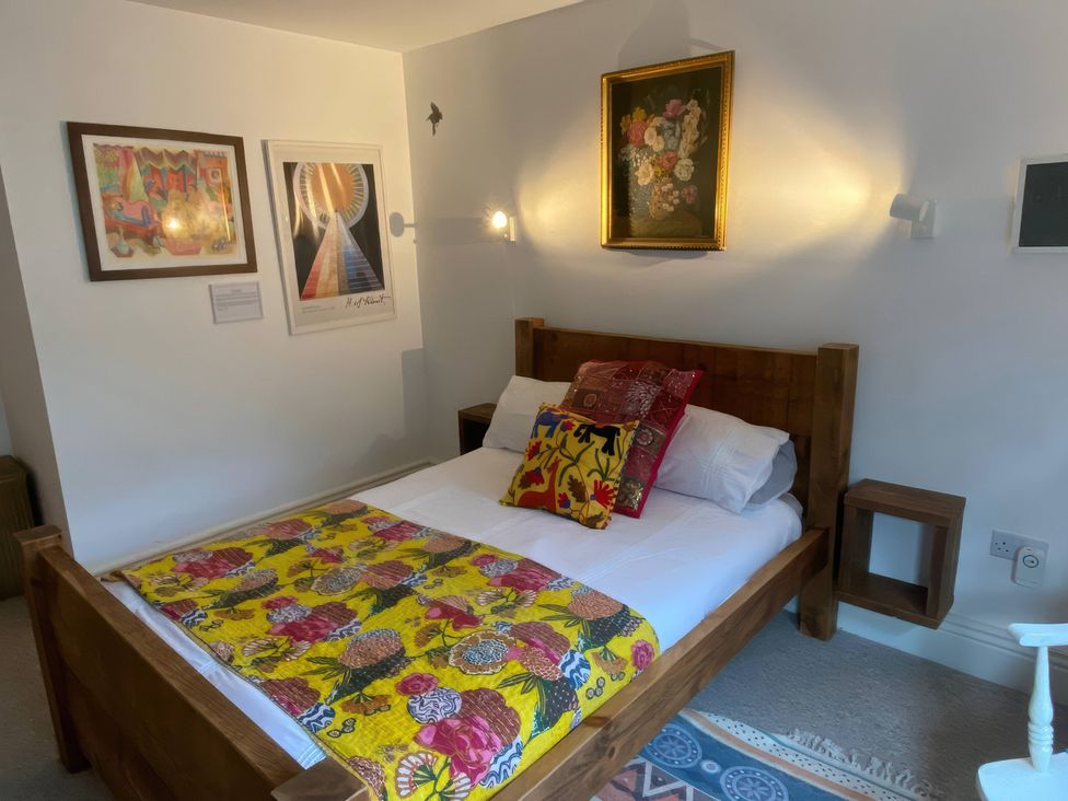 A bedroom with bed and artwork at Church Retreat in St. Leonards-on-Sea