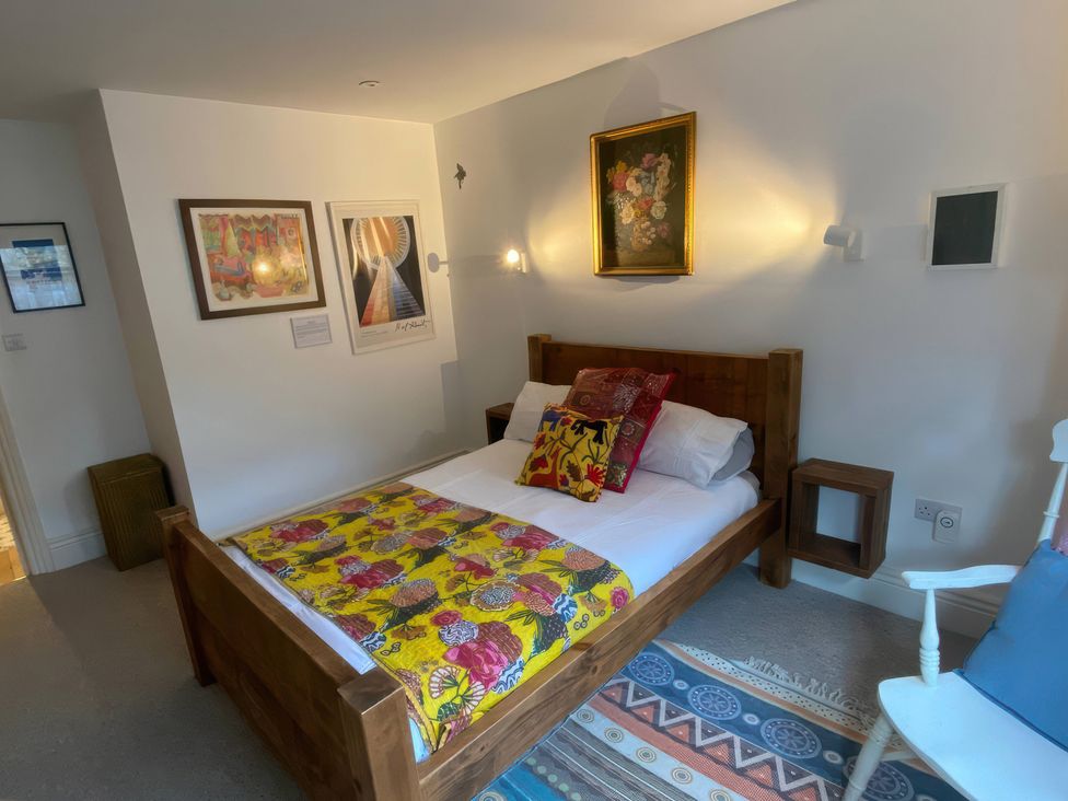 A bedroom with a bed and artwork at Church Retreat in St. Leonards-on-Sea