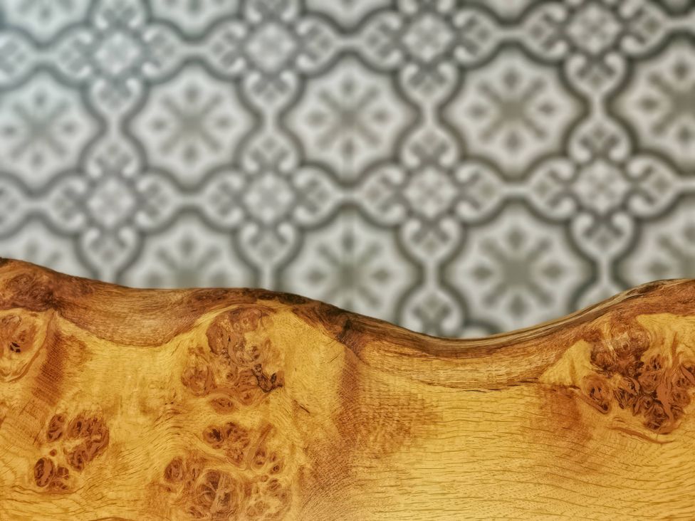 A close-up of a wooden edge with a decorative tile background at Church Retreat in St. Leonards-on-Sea