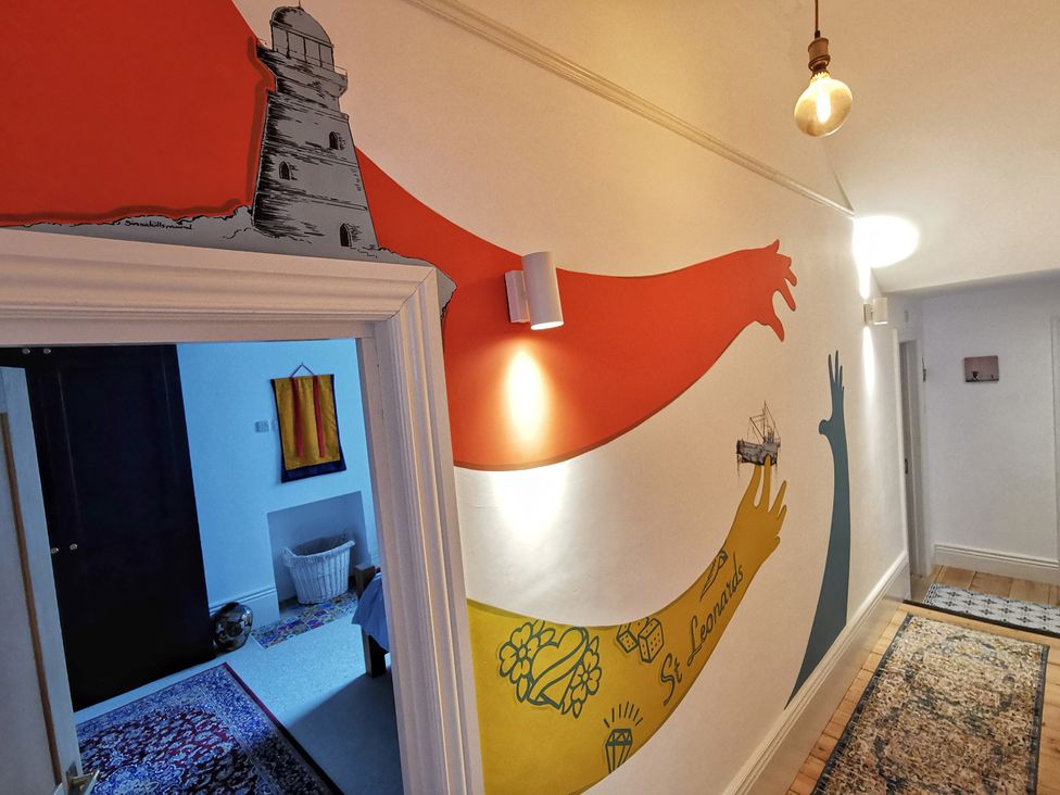 A hallway with decorative wall art and light fixture at Church Retreat in St. Leonards-on-Sea