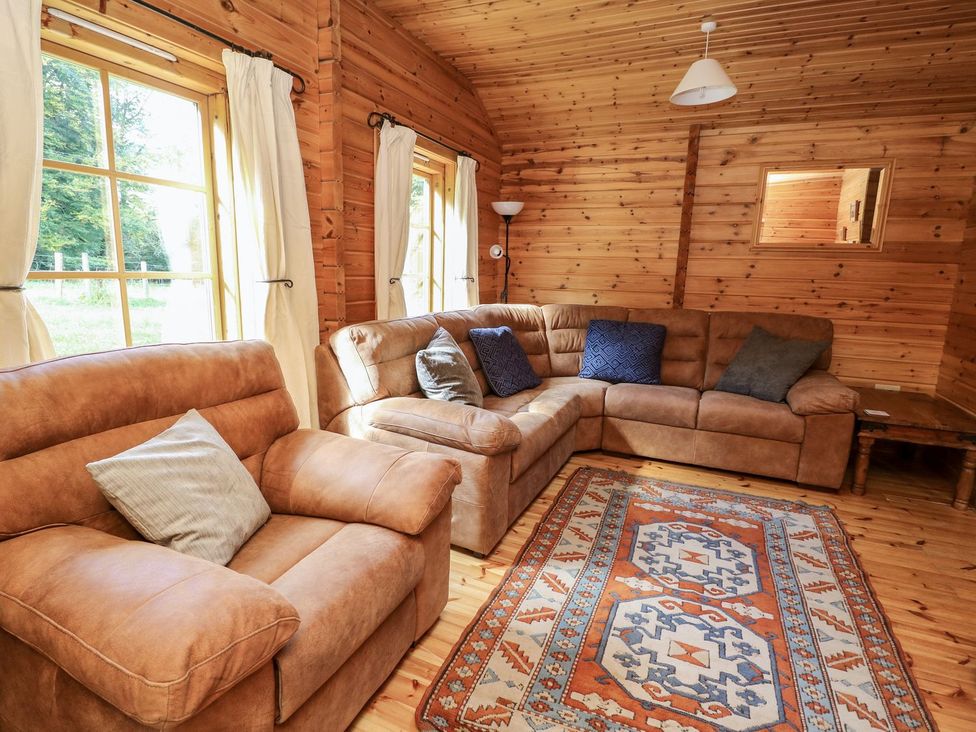 A living room with a sofa and armchair at Dan Y Coed near Beggar's Bush near Presteigne