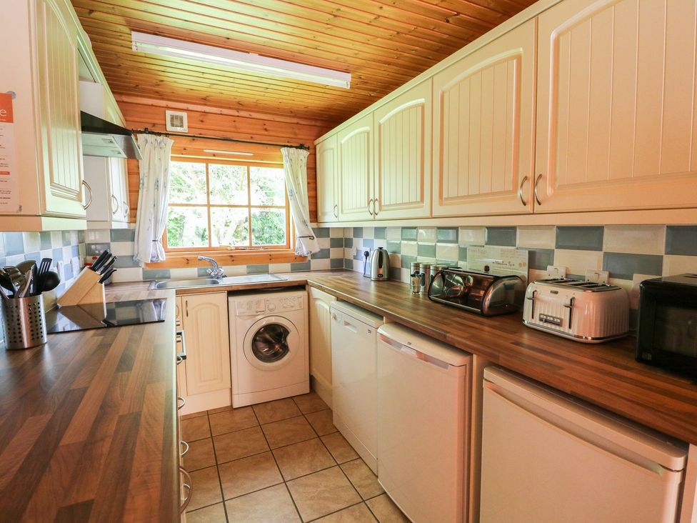 A kitchen with appliances and cabinets at Dan Y Coed near Presteigne