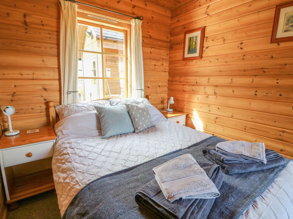 A bedroom with a bed and window at Dan Y Coed near Presteigne