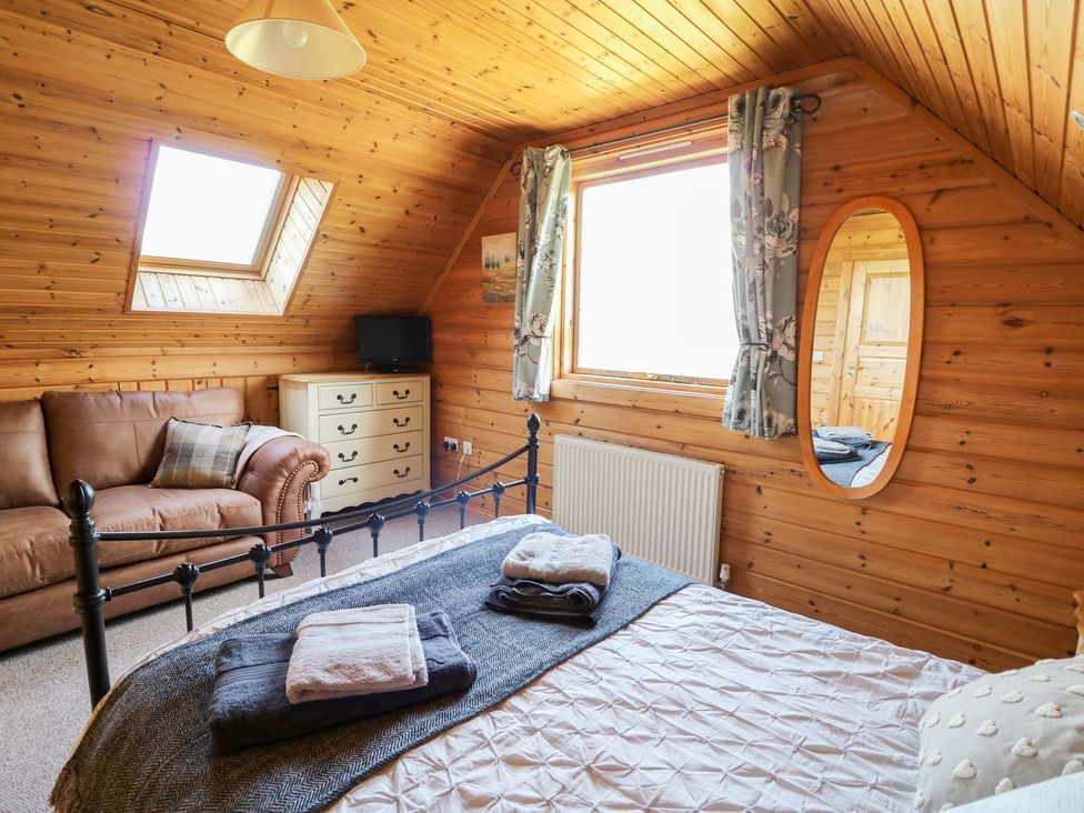 A bedroom with a bed and sofa at Dan Y Coed near Beggar's Bush near Presteigne