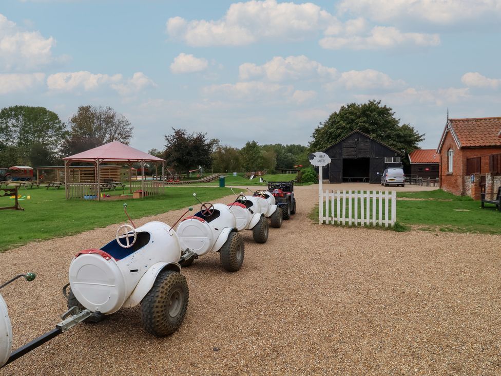 A row of carts parked on a gravel path at Molly (Cow Shed 6) Woodbridge