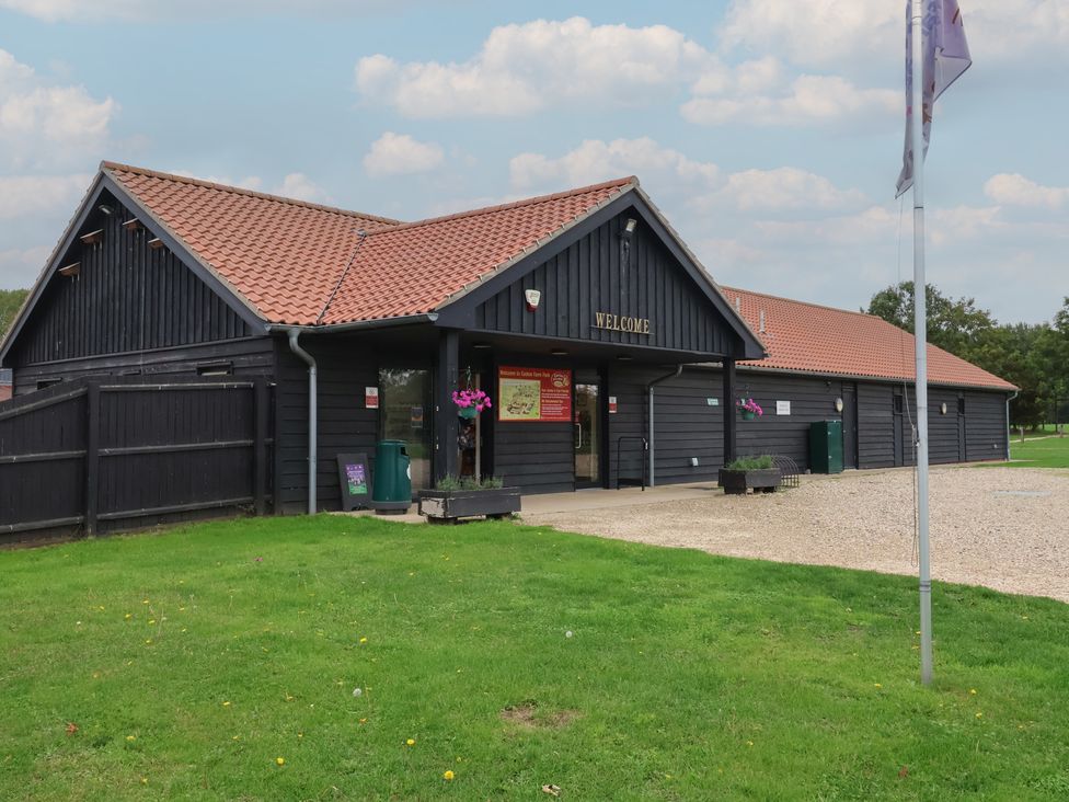 A building with a welcome sign and landscaping at Molly (Cow Shed 6) Woodbridge