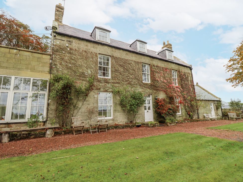 A building with windows and garden at Elford Farmhouse Seahouses