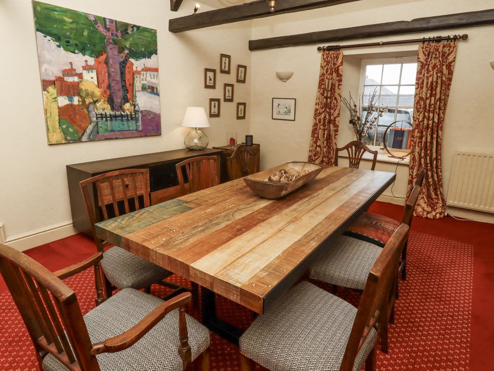A dining room with a table and chairs at Elford Farmhouse in Seahouses