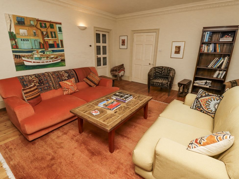 A living room with a sofa and coffee table at Elford Farmhouse in Seahouses