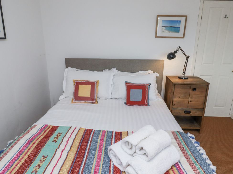 A bedroom with a bed and nightstand at Elford Farmhouse in Seahouses