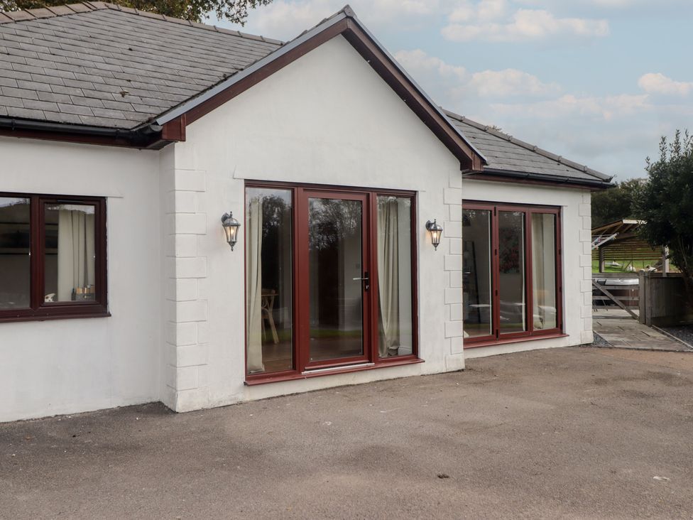 An exterior view of a house with doors and windows at The Lodge in Bridgend