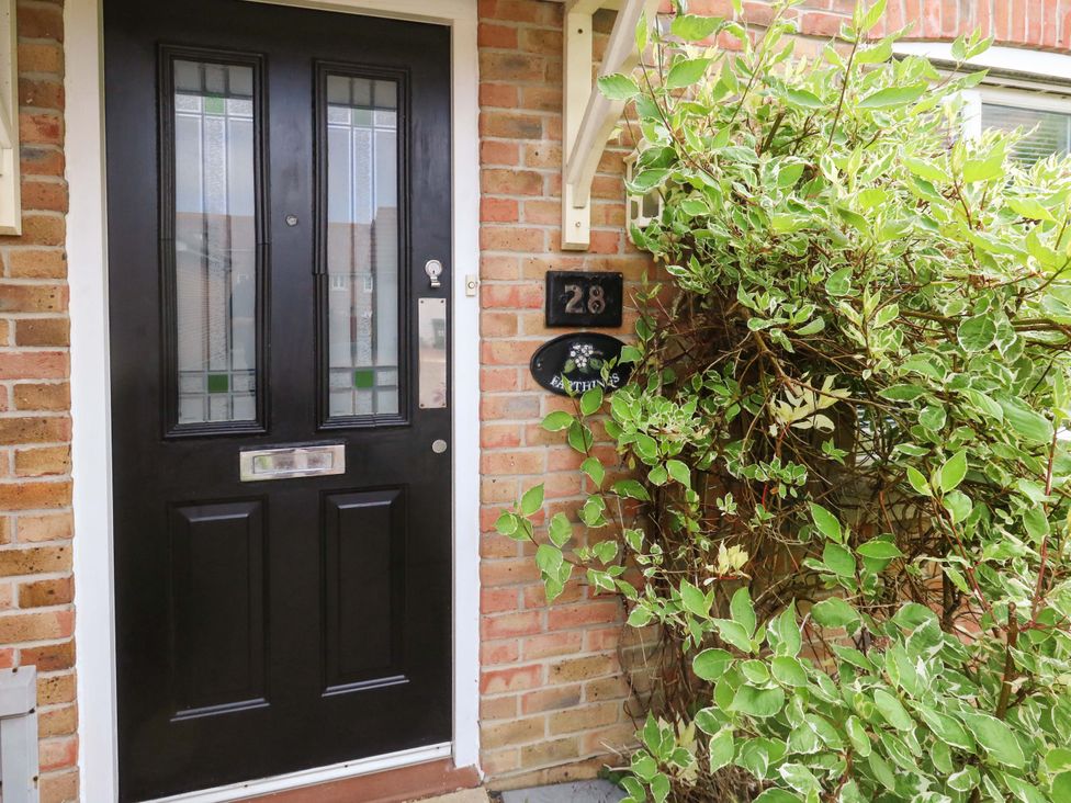 A front door with number 28 and foliage at Farthings in Weymouth