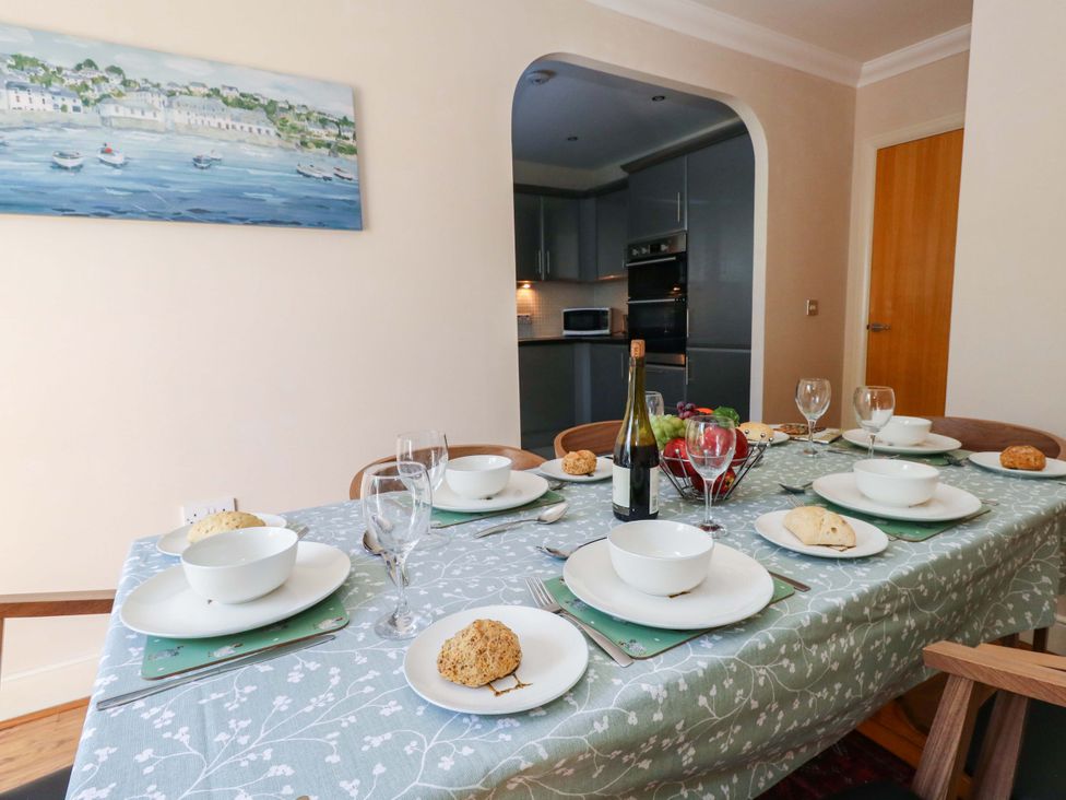 A dining room with a table set for a meal at Farthings in Weymouth
