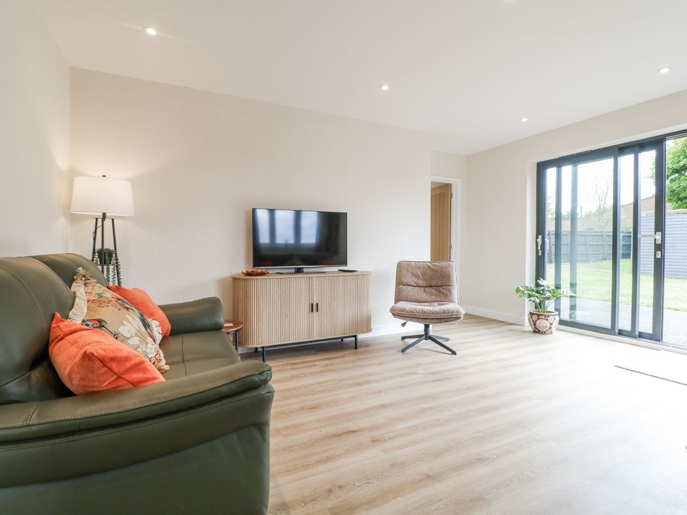 A living room with a sofa and television at Fields View in Edingale near Alrewas