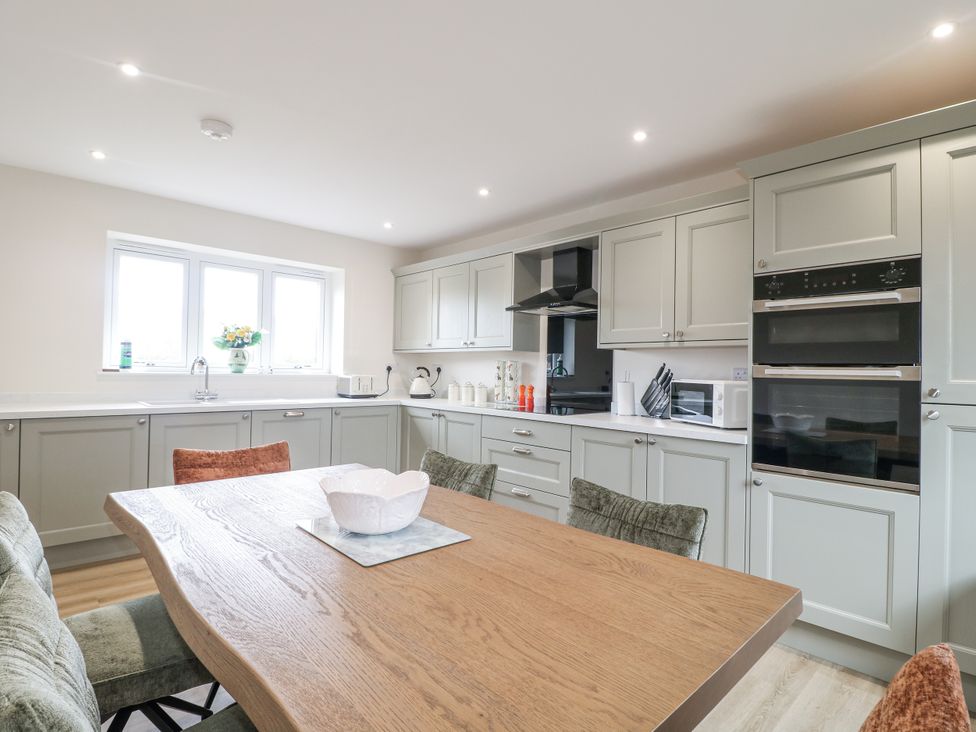 A kitchen with a dining table and chairs at Fields View, Edingale near Alrewas