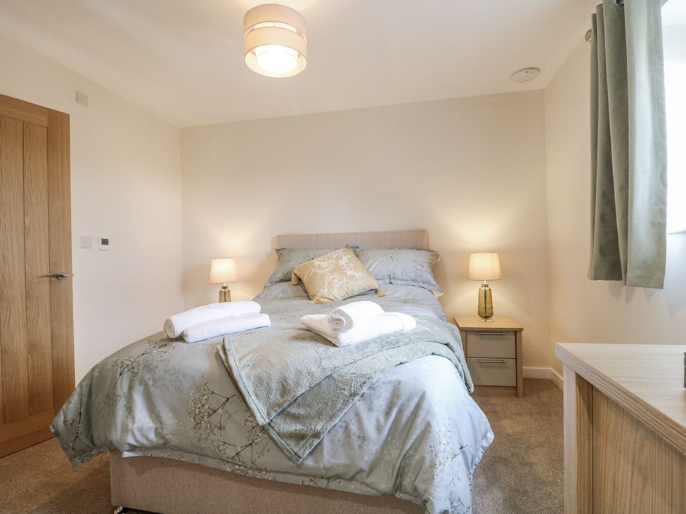 A bedroom with a bed and lamps at Fields View in Edingale near Alrewas