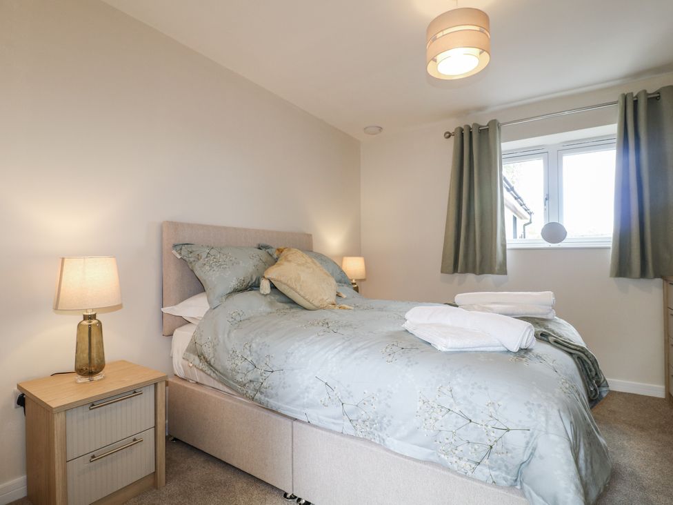 A bedroom with a bed and nightstand at Fields View Edingale near Alrewas