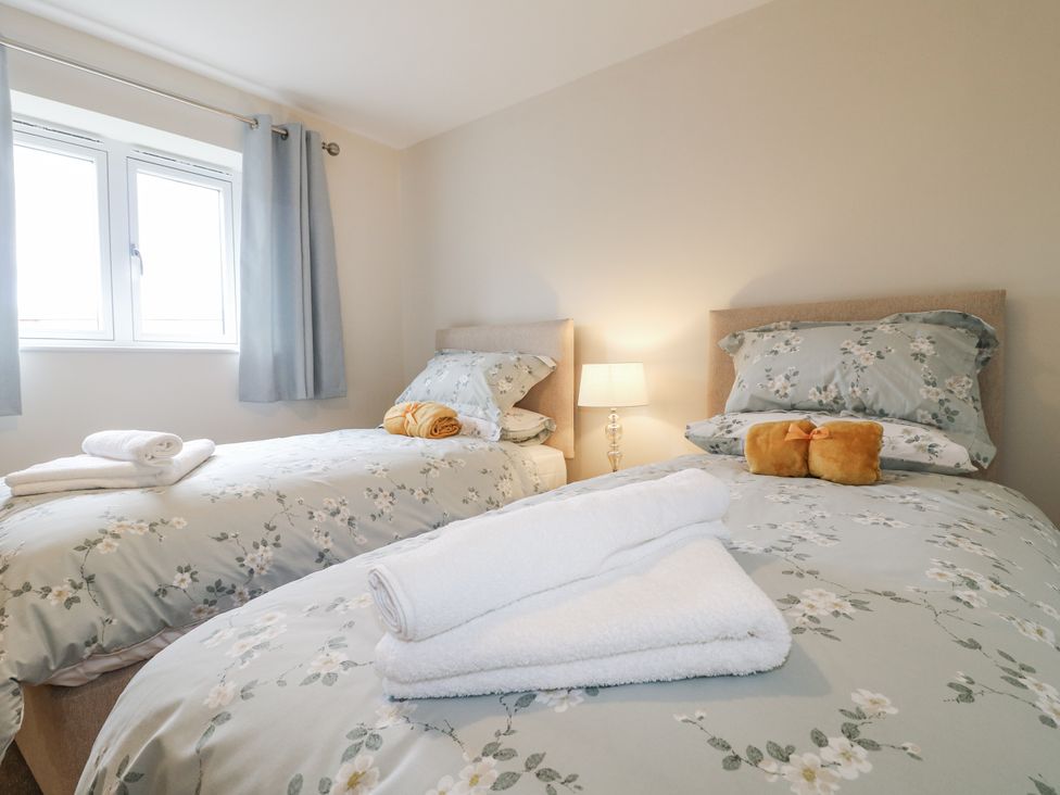 A bedroom with two beds and a lamp at Fields View Edingale near Alrewas