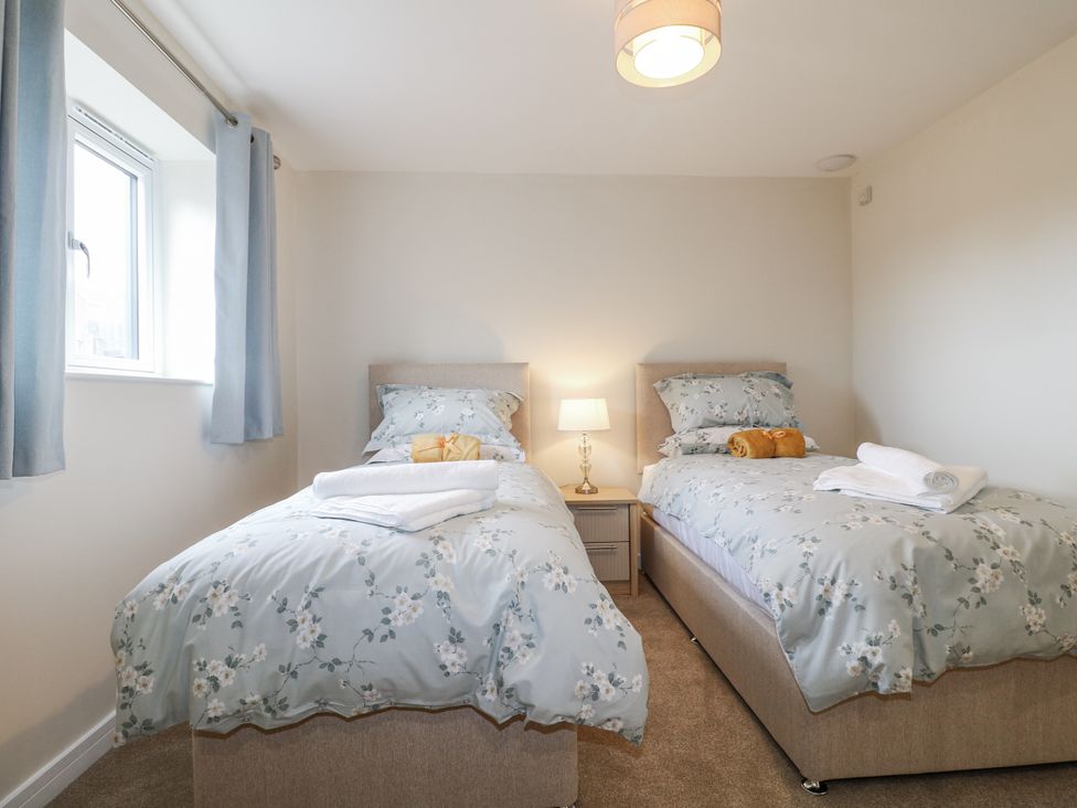 A bedroom with two beds and a lamp at Fields View in Edingale near Alrewas