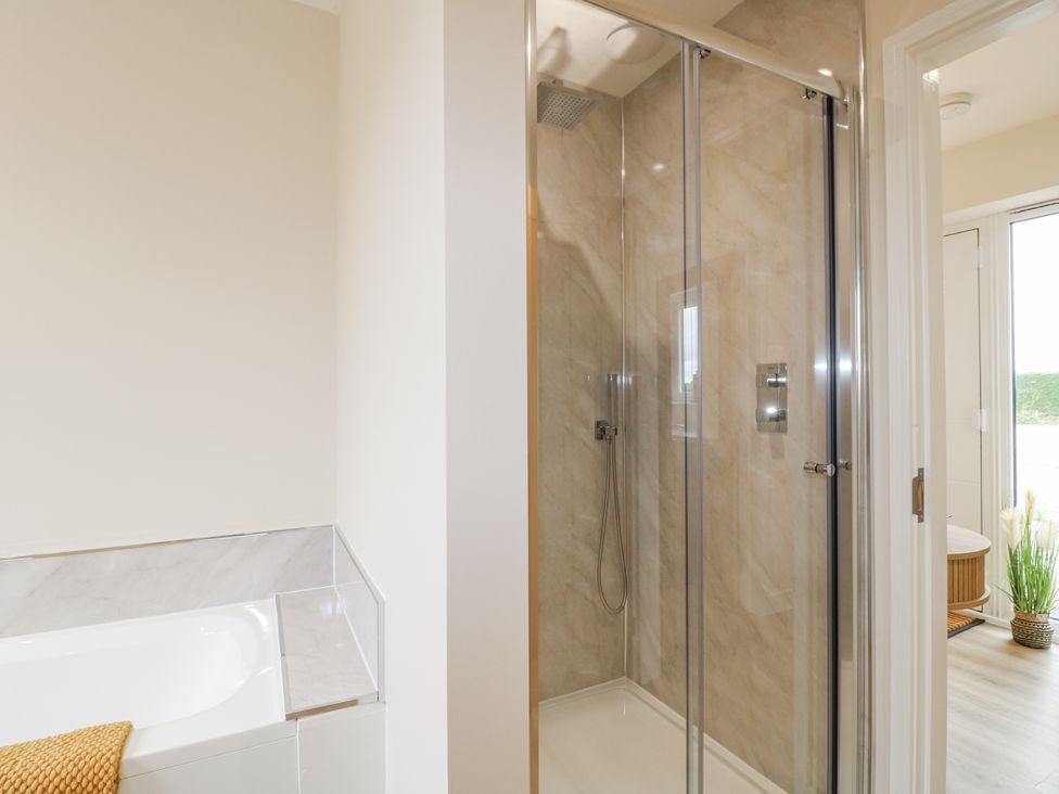 A bathroom with a shower and bathtub at Fields View in Edingale near Alrewas