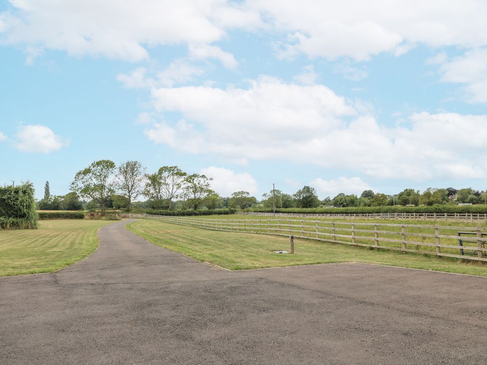 A pathway with trees and a fenced field at Fields View in Edingale near Alrewas