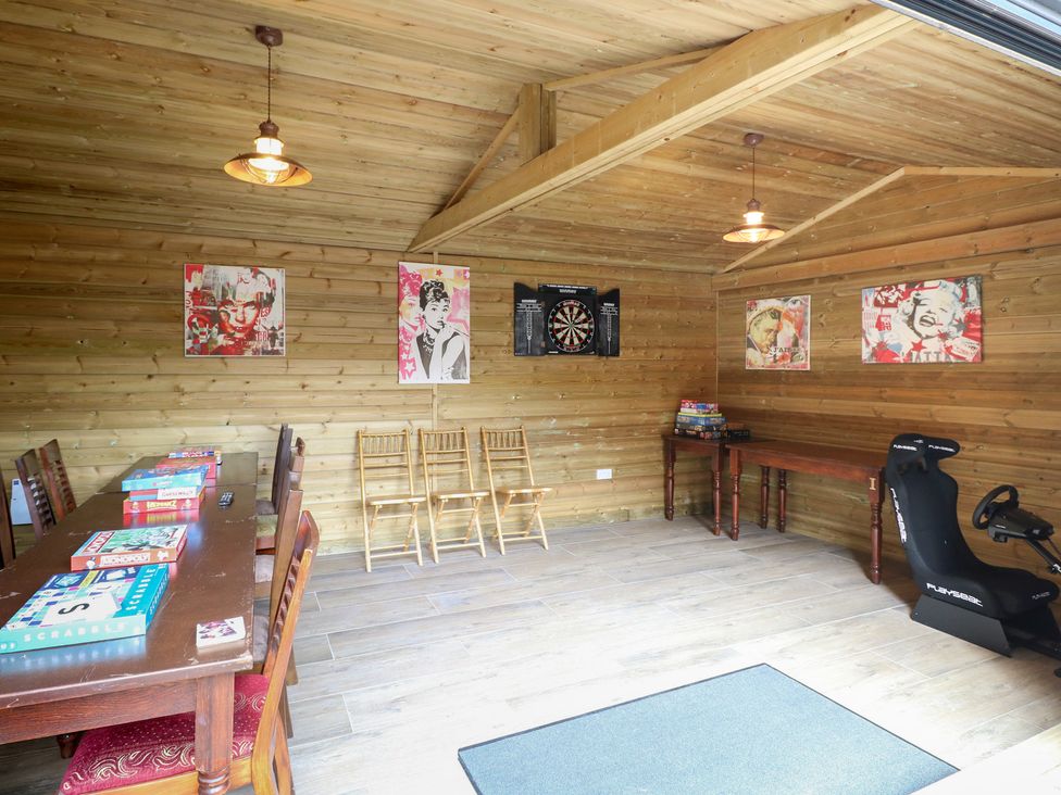 A snug with a dartboard and table for board games at The Burleigh in Hunstanton